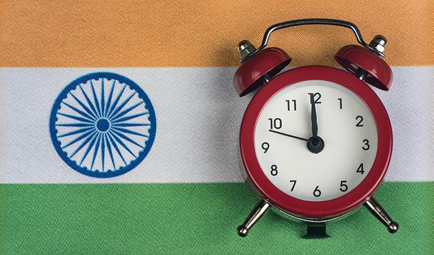 The Indian flag with an alarm clock on top. This signifies the extensive EB-5 retrogression the country is experiencing for United States visas.