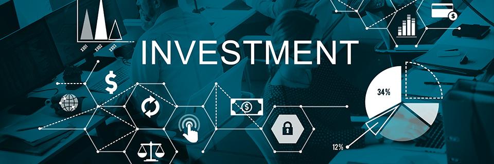 An office with people in front of their computers in the background, with investment capital icons on the foreground.