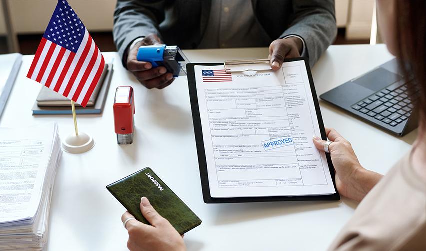 An EB5 investor holding visa application documents at a United States Citizenship and Immigration Services office.