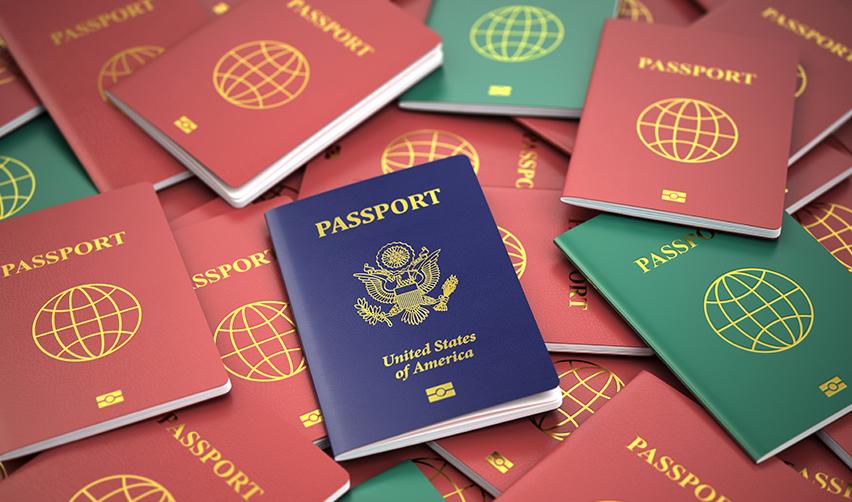 A United States passport on top of a stack of passports, symbolizing the EB5 visa pathway to citizenship through a minimum investment.