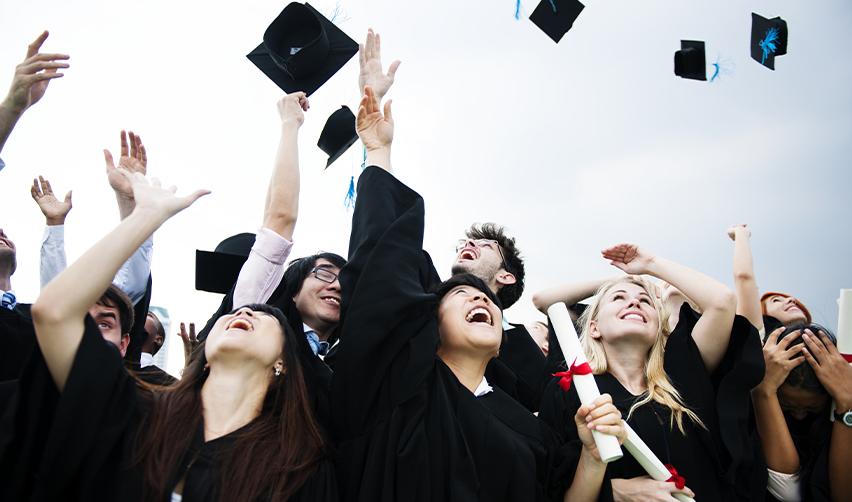 A group of U.S. college graduates celebrating their graduation.