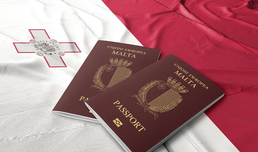 Two Maltese passports on top of the Maltese flag, symbolizing Malta golden visa.
