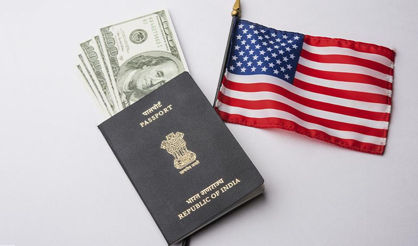 A valid passport with a significant amount of money in it next to the U.S. flag, symbolizing the American dream.