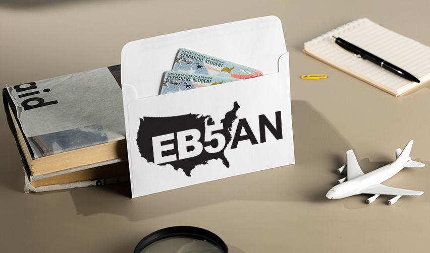 An envelope with the EB5AN logo on it, with two Green Cards inside.