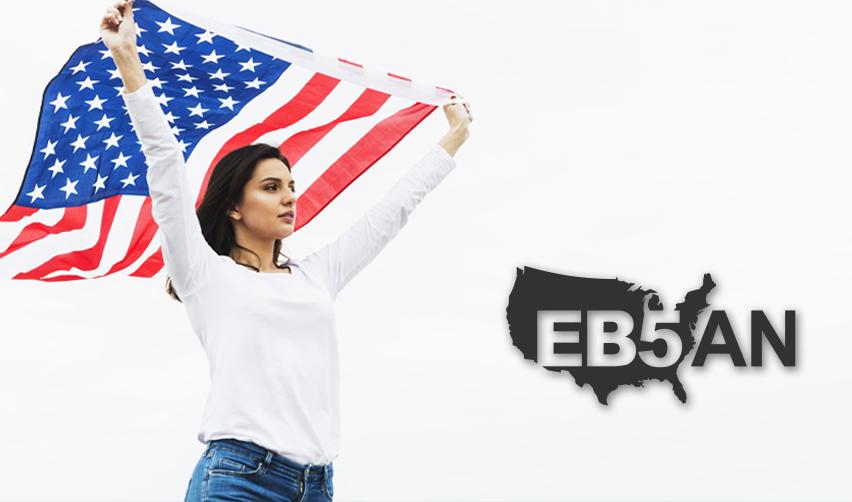 A US citizen holding up the American flag next to the EB5AN logo.