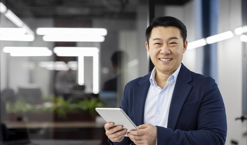 An Asian EB5 investor smiling at the camera.