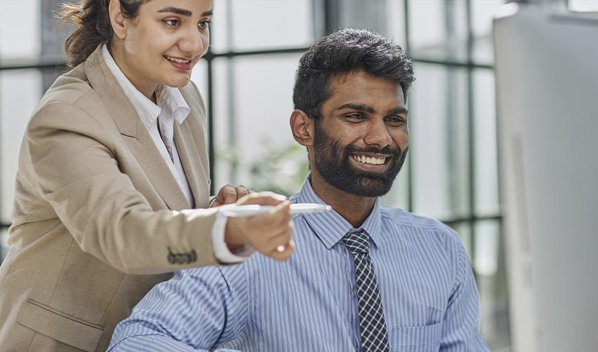 An Indian EB5 investor examining his EB5 visa process on a laptop with the help of an immigration attorney.