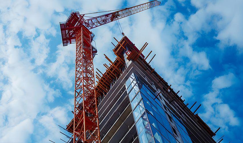 A crane next to a tall building