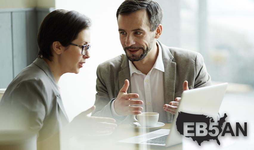 An EB5 regional center principal explaining the process of getting a green card through investment in real estate to a potential EB5 investor, with the EB5AN logo on the corner.