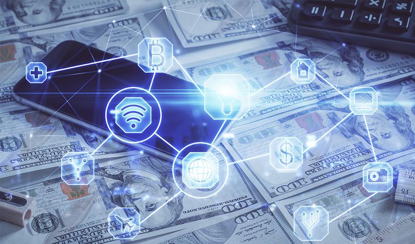 A phone on top of investment capital and digital icons referring to cryptocurrencies.