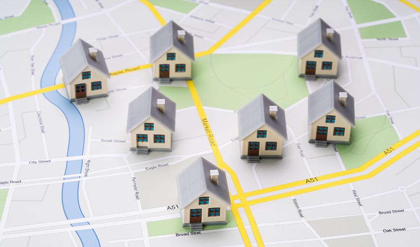 Model houses placed on a map, marking the best EB5 investment locations in targeted employment areas.