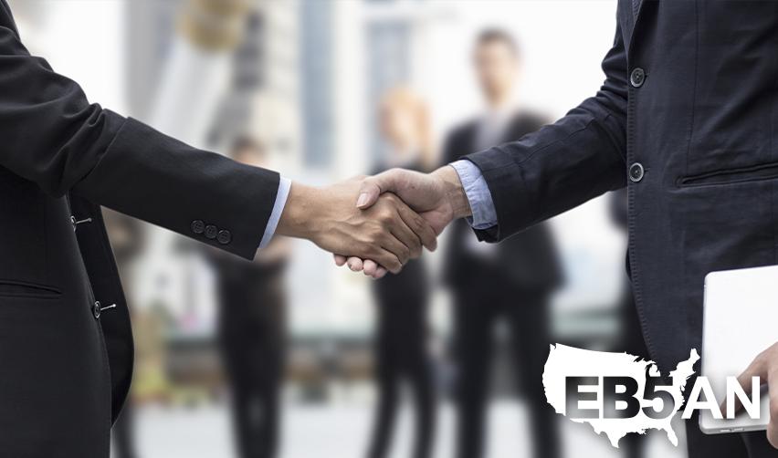 A handshake between a regional center managing partner and an EB5 investor, with the EB5AN logo on the corner.