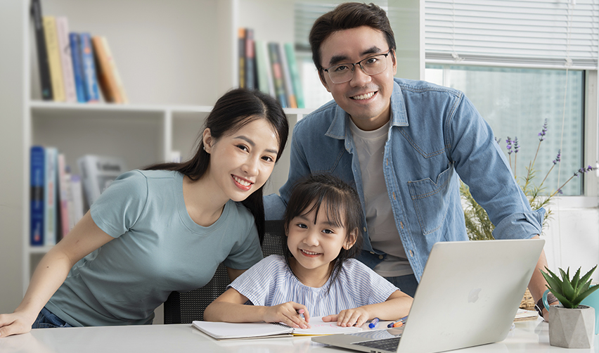 A family of Asian EB5 green card holders smiling at the camera.