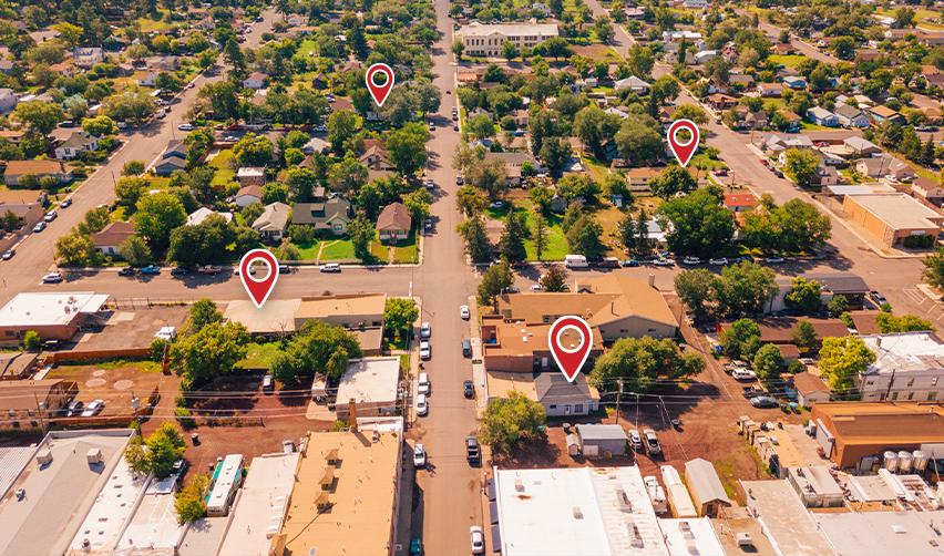 Some red pins dropped on locations in an urban residential area, symbolizing eb5 high unemployment targeted employment areas in a metropolitan statistical area.