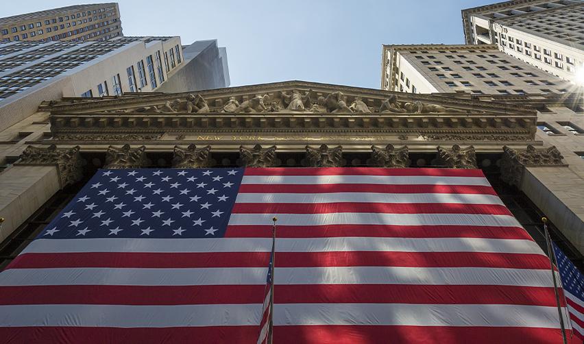 American flag displayed on a prominent U.S. building, symbolizing the opportunities and freedoms associated with an EB5 Green Card.