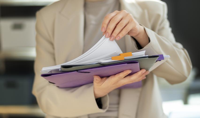 Either a manager at an EB5 regional center or an immigration lawyer holding a stack of employment based permanent residency documents to make the transition process easy from L1 visa to green card.