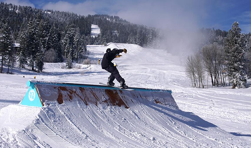 A person on a snowboard on a ramp