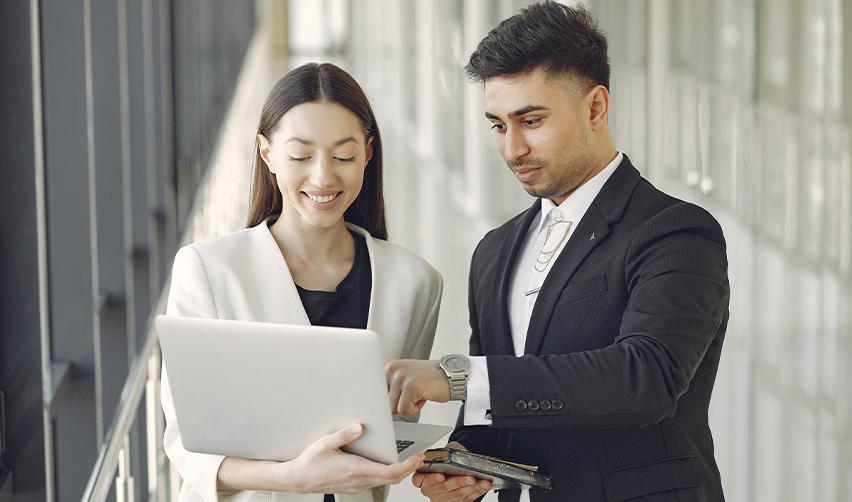 Two business professionals collaborating on an EB5 visa application in an office, symbolizing strategic planning for a successful U.S. residency journey.