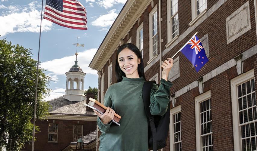 A young EB5 resident visa holder or green card holder with a New Zealand flag in front of a university or New Zealand embassy in America.