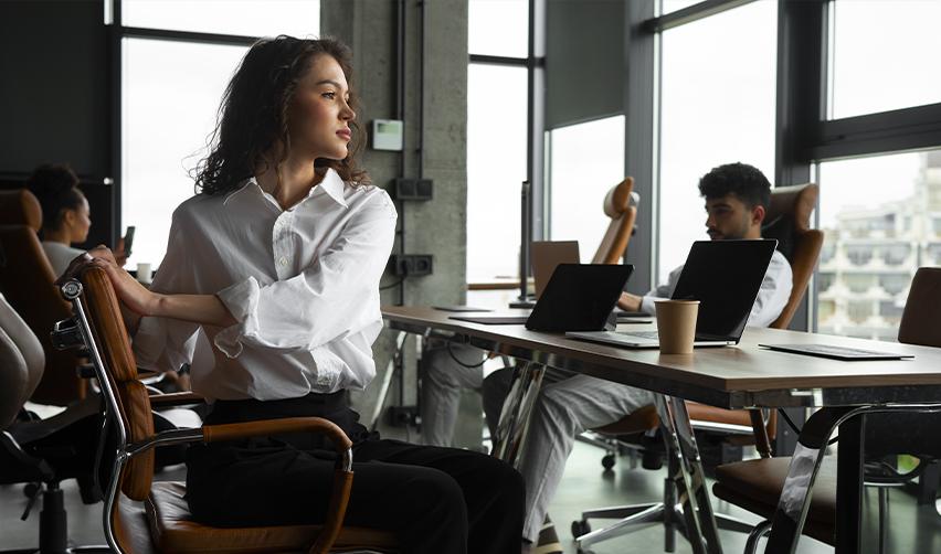 Confident professional woman in an office, showcasing the freedom to work in America as an EB5 investor.