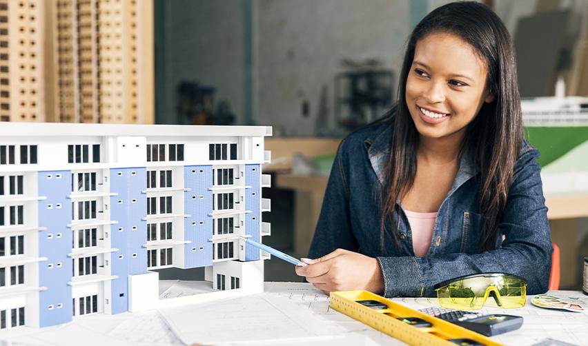Investor evaluating a reliable EB5 real estate project with a scale model and professional tools, emphasizing due diligence in selecting a strong investment for US permanent residency.