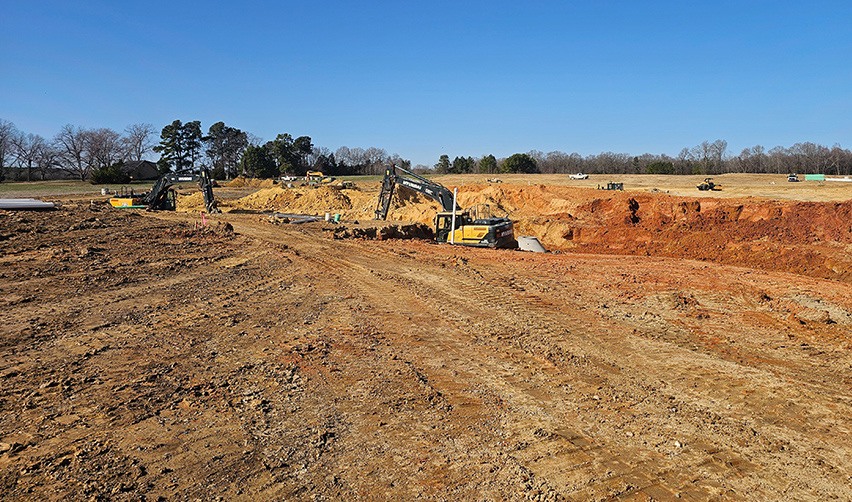 A construction site with excavators and dirt