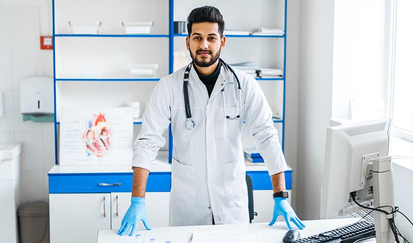 Indian doctor in a modern clinic, showcasing how the EB5 visa program offers a streamlined pathway for Indian physicians seeking U.S. residency compared to H1B limitations.