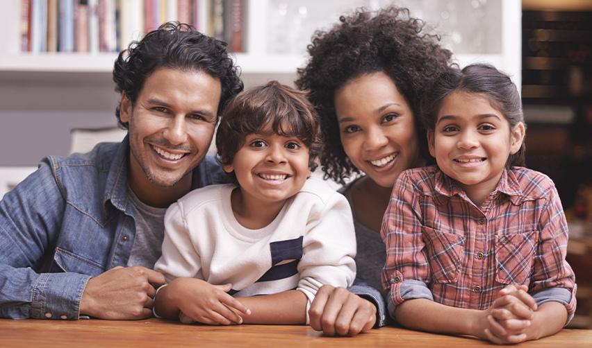 A happy family representing Brazilian green card holders who successfully obtained green cards through the EB5 visa, as recognized by U.S. Citizenship and Immigration Services.