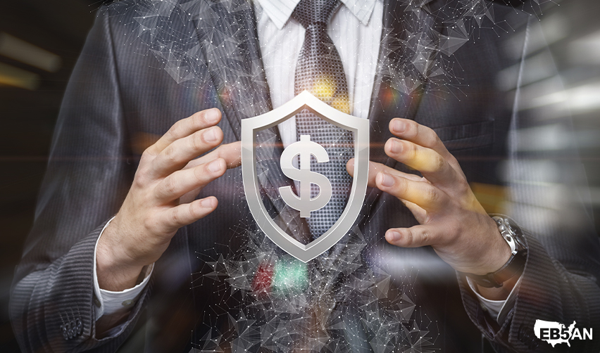 A businessman in a suit protects a glowing shield with a dollar sign, symbolizing financial security in EB5 investments. Choosing an affiliated regional center and NCE like EB5AN reduces financial risks and ensures project stability.