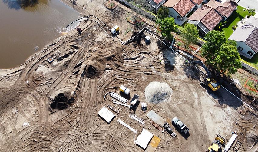 A construction site with a bulldozer digging a hole