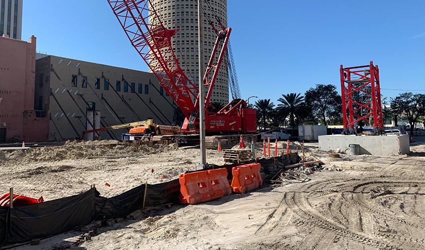 A construction site with a crane and a building