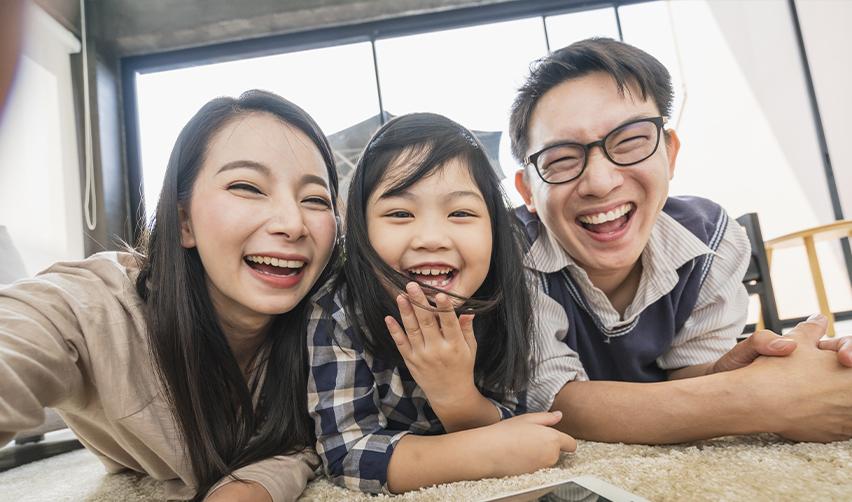 A happy Taiwanese family celebrating their green card after applying to the u.s. citizenship and immigration services under a family sponsorship visa.