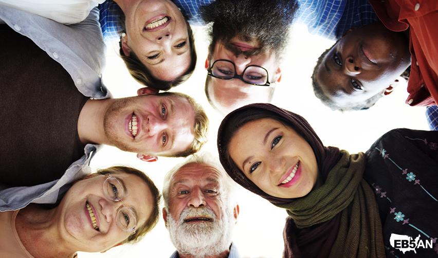 Group of diverse, smiling individuals of different ages and ethnicities, representing global EB5 investors and families pursuing U.S. residency with the help of EB5AN.