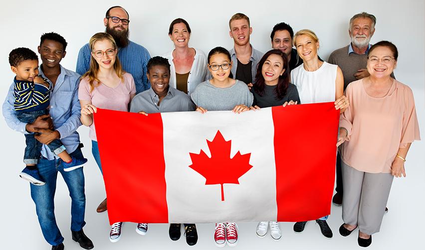 Diverse group of smiling Canadian citizens holding a Canadian flag, representing families exploring U.S. residency through the EB5 visa program.