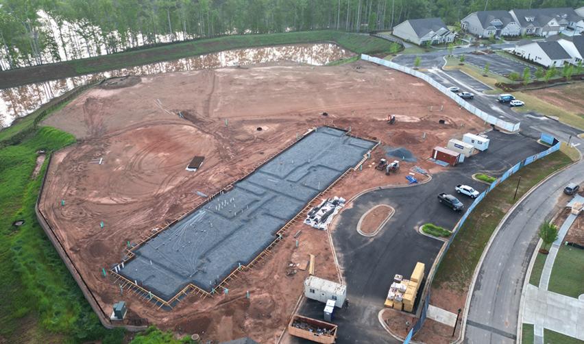 Aerial view of the construction site at Cresswind at Spring Haven, showing the clubhouse foundation being laid.
