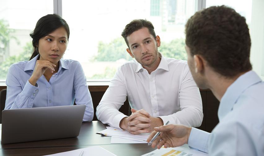 EB5 investors consulting with financial and legal advisors to assess conflict of interest risks in a regional center-sponsored project.
