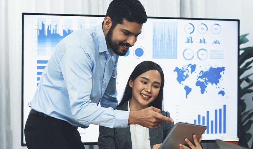 Indian and Asian professionals reviewing EB5 investment data on a tablet, with global charts and visa statistics in the background symbolizing international investor strategy.