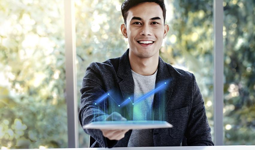 Confident investor holding a digital growth chart, symbolizing success in EB5 investment projects and potential Green Card approval.