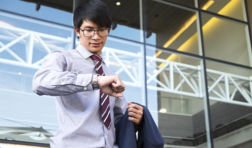 EB5 investor checking his watch, symbolizing the urgency to start the EB-5 process before visa backlogs begin.