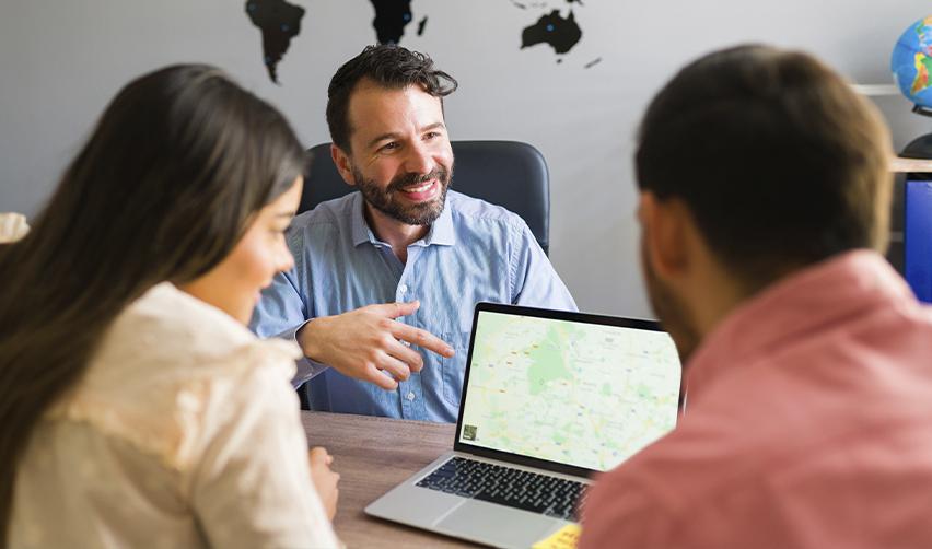 EB5 investment advisor discussing project locations with a couple, highlighting the importance of choosing the right regional center.