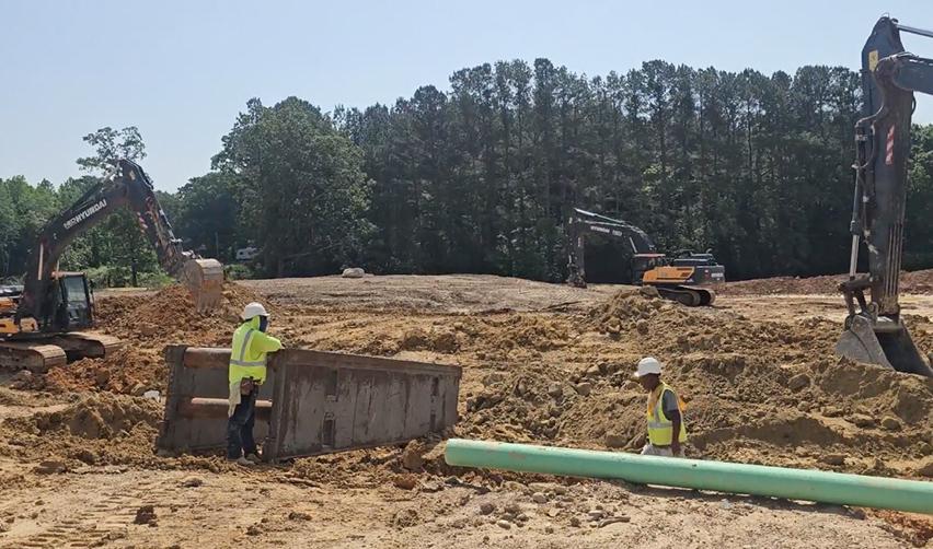 A group of men in hardhats working at a construction site