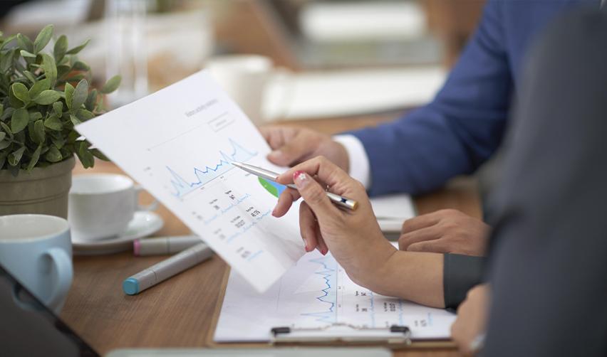 EB5 investors analyzing investment reports and job creation data to ensure alignment with immigration goals and financial integrity.