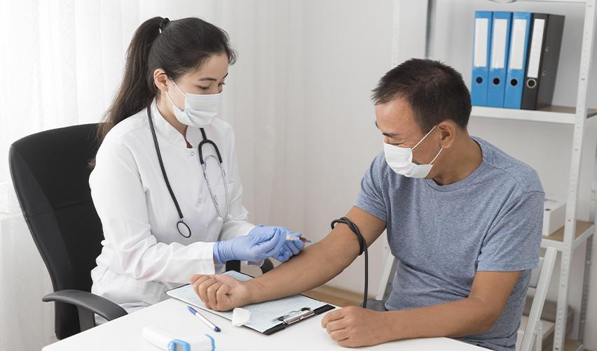 USCIS-authorized doctor administering a blood test as part of the EB5 immigration medical examination for Form I-693.