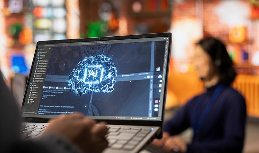 Close-up of a laptop screen showing a glowing digital brain symbolizing AI technology, with a blurred office background, representing EB5 investors using AI tools for project due diligence.