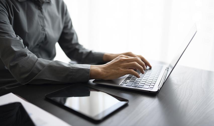 EB5 investor using AI prompts on a laptop to evaluate safe immigration projects and investment options.