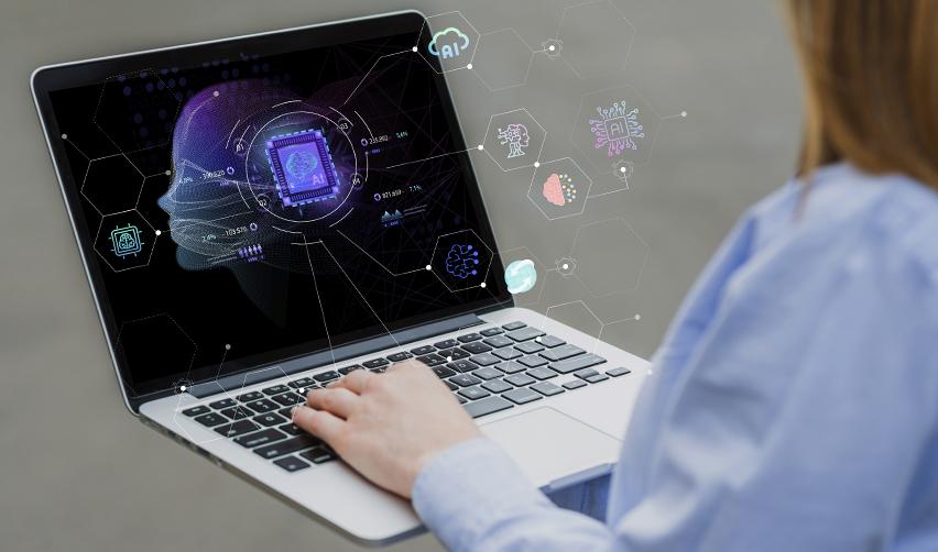 Close-up of an investor using a laptop with AI data visualization on screen, symbolizing how EB5 investors apply artificial intelligence tools to evaluate regional centers.