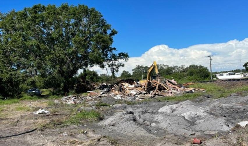 An excavator works amid piles of demolished building debris on the Terra Ceia EB5 project site in Palmetto, Florida.