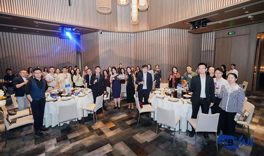 A group of people standing around tables