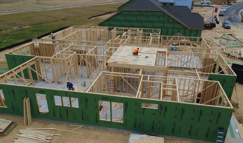 Workers building a model home at the Rocky River EB5 project site.