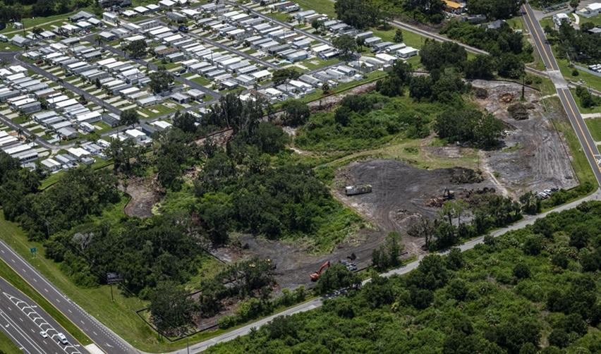 High-angle aerial photo of the Terra Ceia EB5 project site in Palmetto, Florida, showing cleared land, heavy equipment, and surrounding greenery.
